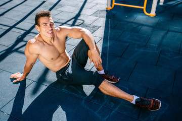 Sports. Smiling Man With Fit Body In Yellow Sportswear Resting on Gray Grunge After Running,...