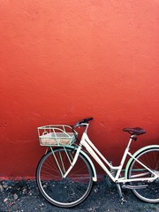 Stylish bicycle in front of red wall