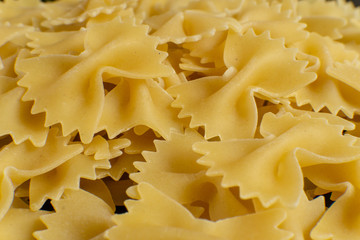 background of some farfalle pasta in the form of bows. texture. pattern
