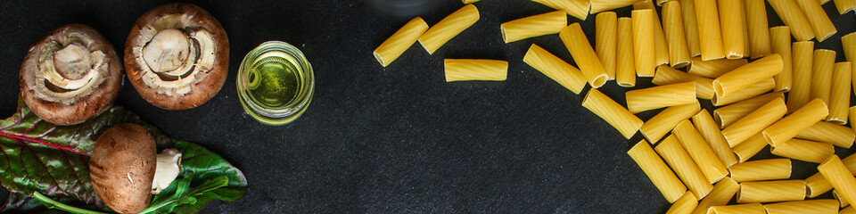 pasta Tortiglioni and ingredients for mushroom sauce (Italian main course Maccheroni, Rigatoni) menu concept. food background. top view. copy space