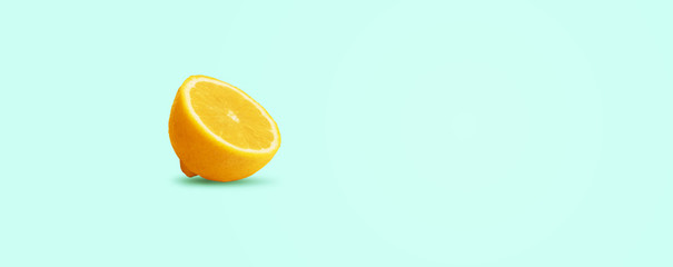 sliced lemon on blue background, panoramic image with space for text