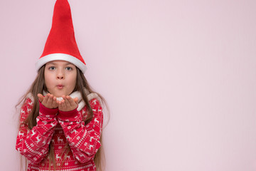 A portrait of a pretty young girl, girl blowing on her palms