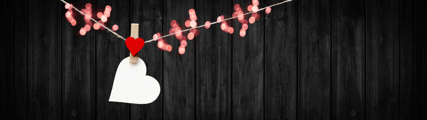 Happy Valentine's Day background banner panorama - White heart hang on wooden clothes pegs with...