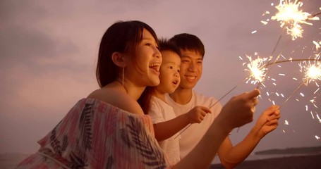 happy family celebrating new year with sparklers - Powered by Adobe
