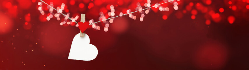 Happy Valentine's Day background banner panorama - White heart hang on wooden clothes pegs with...
