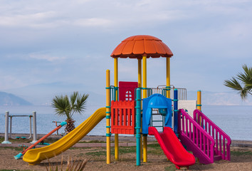 Colorful playground for children. Playground with seascape in background.