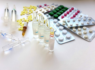 Pharmaceuticals. Antibiotics, various pills, syringes, ampoules on a white background.