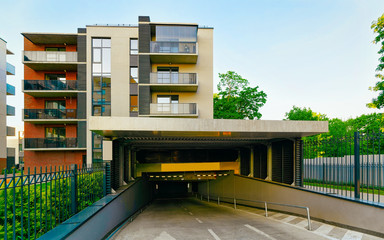 Garage at Apartment in residential building exterior. Parking of Housing structure at blue modern...