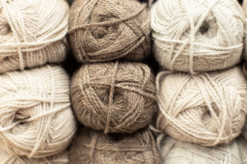 Beige and grey woolen threads in balls for knitting and handmade.