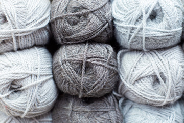 Gray woolen threads in balls for knitting and handmade.