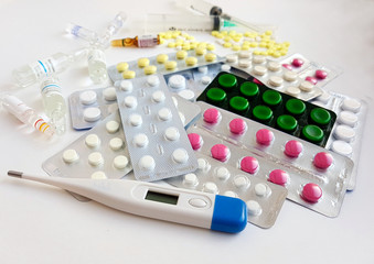 Pharmaceuticals. Antibiotics, various pills, syringes, ampoules on a white background.