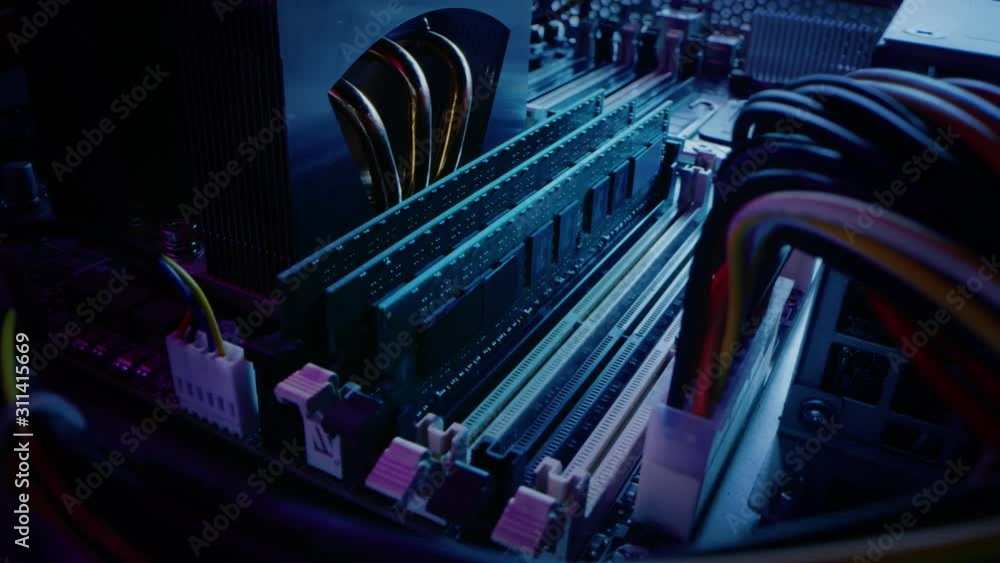 Poster close-up moving macro shot: person's hands installs ram memory into computer motherboard slot. techn