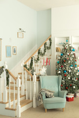 Blue chair near the Christmas tree, Christmas room interior.