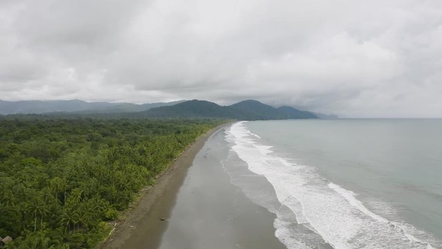 Aerial shot of a blacksand beach during a cloudy day on the Pacific Coast, Colombia.