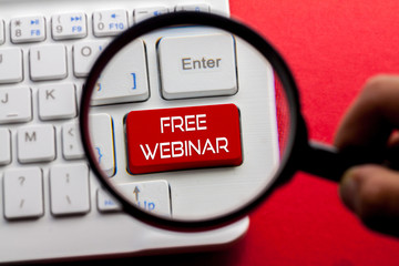 FREE WEBINAR word written on keyboard view with magnifier glass