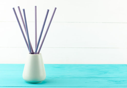 vase with aroma sticks turquoise background