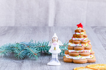 Christmas tree with decorations on wooden background.