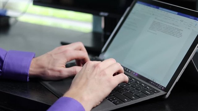 Hands typing on keyboard into a word processor Office worker making content for the job on a laptop pc