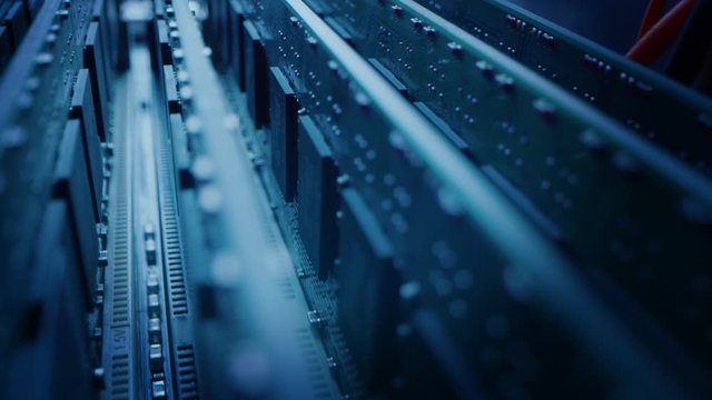 Close-up Moving Macro Shot: Inside of the Computer Case. Camera Moves Over PCB Motherboard, Showing Multiple Slots with RAM Memory Installed, and Other System Hardware. Stylish Neon, Black Colors