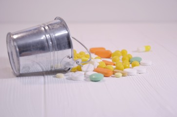 glass jar with yellow vitamins on a white background with space for text