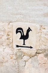 Arrow pointer with black cock on the way to Church of Saint Peter in Gallicantu, located on Mount Zion, Jerusalem, Israel