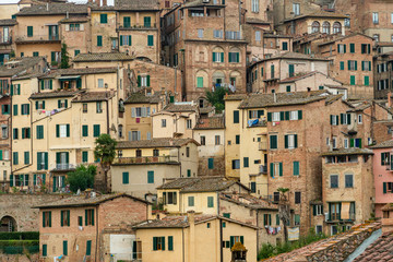 Fototapeta na wymiar Pattern houses beackground, Old residential houses in medieval city of Siena, Italy