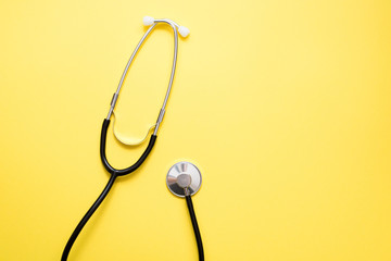 stethoscope phonendoscope on a yellow background, copy space