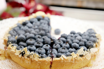Blueberry pie with whole berries and almond. Sliced delicious dessert