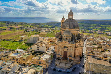 Aerial view of Rotunda St. John Baptist Church. Countryside of Gozo island, cloudy blue sky. Malta...