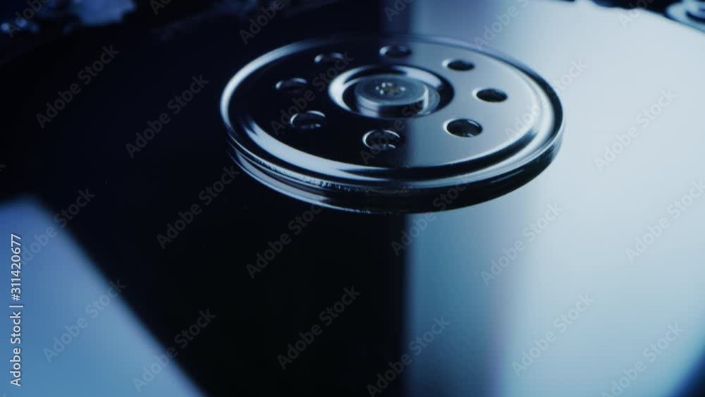 Poster close-up macro shot: open modern hard drive disc with head resting on a platter. hdd with internal c
