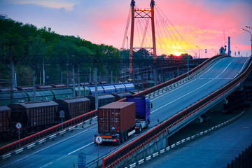 truck with container rides on the road, railroad transportation, freight cars in industrial seaport...