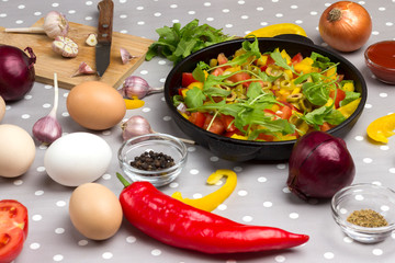 Set of vegetables for a healthy eating, yellow and red peppers, tomatoes, onions, garlic. Sliced vegetables in pan. Top view..