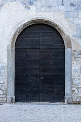 Fototapeta na wymiar ancient wooden door of entrance building, Europe