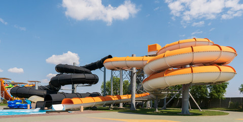 Outdoor water park. Multi-colored slides and pools.