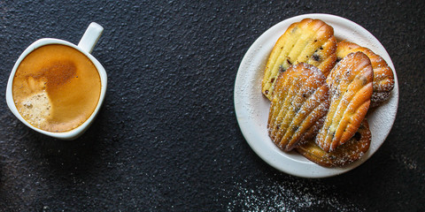 Madeleine cookies, sweet dessert and coffee on the table (delicious pastries, sweets) menu concept. food background. top view. copy space