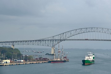A freighter passes under the bridge to the Americas in the Panama Canal
