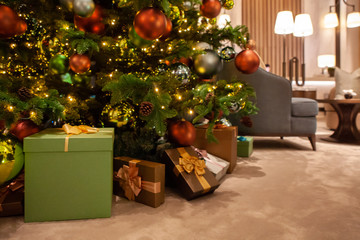 Season Greeting. Luxury Golden, Silver, Red and Green sparkling ball and pine cone ornament for Merry Christmas and Happy New Year festive decoration and celebration on a Christmas tree with presents.