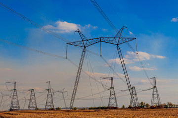 High voltage power line against blue sky
