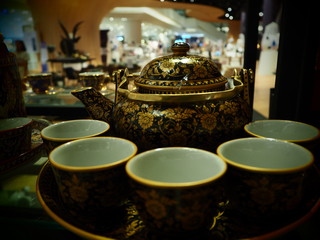 cup of tea with teapot and cups on table