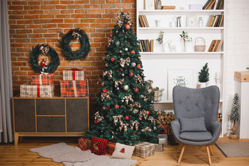 dark interior of the living room in the loft style is decorated with a Christmas tree