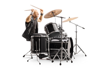Male drummer in a leather vest performing