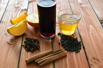 Glintwein of red wine with: orange, cinnamon, pepper, cloves and honey on a wooden background