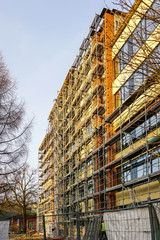 scaffolding arround the house to install thermal insulation of the apartment building facade