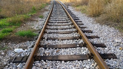 empty rail road track and white pebbles