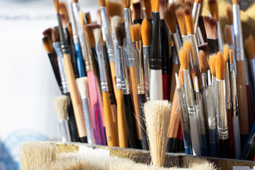 Painting brushes close-up. They have different sizes and colors.