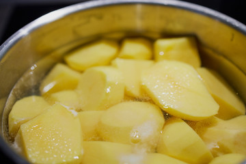 pealed potatoes in a pot with water