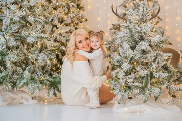Obraz na płótnie Canvas Happy family scene, little girl and mom celebrate Christmas, relationship parents and children 