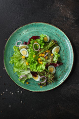 healthy salad corn, quail eggs, leaves mix salad  (healthy food, green vitamins) menu concept. food background. top view. copy space