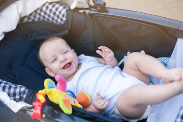 a small child in a stroller on a walk with mom and dad with parents