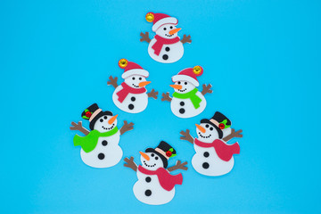 Creative Christmas tree of snowmen on a blue background